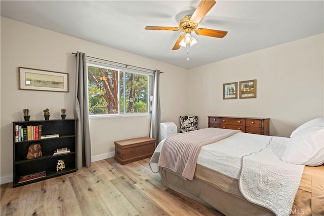 bedroom with ceiling fan and light hardwood / wood-style floors