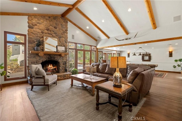 living room featuring high vaulted ceiling, a fireplace, beamed ceiling, and hardwood / wood-style flooring