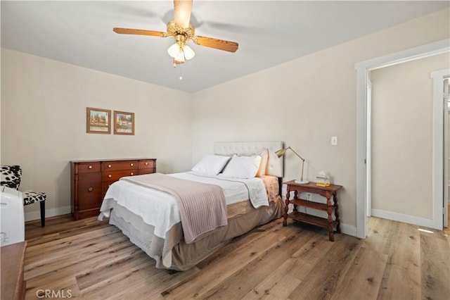 bedroom with ceiling fan and light wood-type flooring