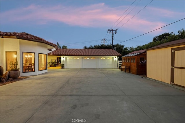 exterior space with a garage and an outdoor structure