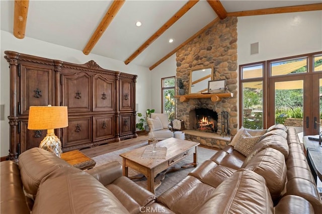 living room featuring high vaulted ceiling, light hardwood / wood-style floors, beamed ceiling, and a fireplace