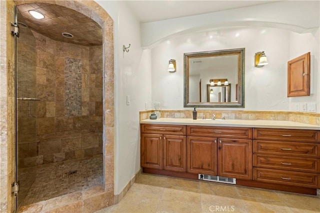 bathroom featuring vanity and a tile shower