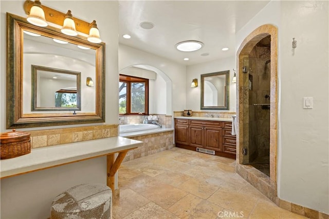 bathroom featuring vanity and shower with separate bathtub