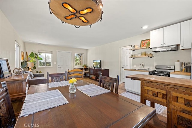 dining area featuring light wood-type flooring and sink