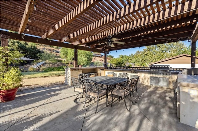 view of patio with ceiling fan, area for grilling, and a pergola