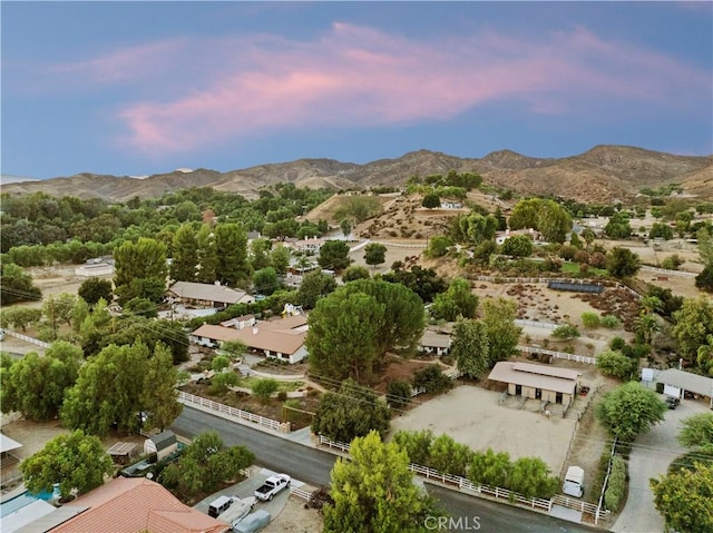 aerial view at dusk featuring a mountain view