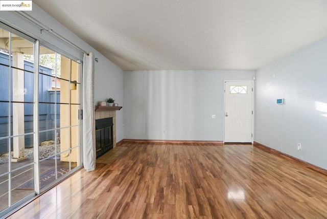 unfurnished living room with hardwood / wood-style floors and a fireplace