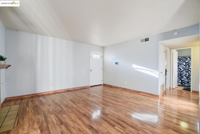 unfurnished living room featuring hardwood / wood-style flooring