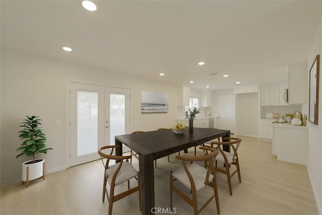 dining area featuring a healthy amount of sunlight, french doors, and light hardwood / wood-style flooring