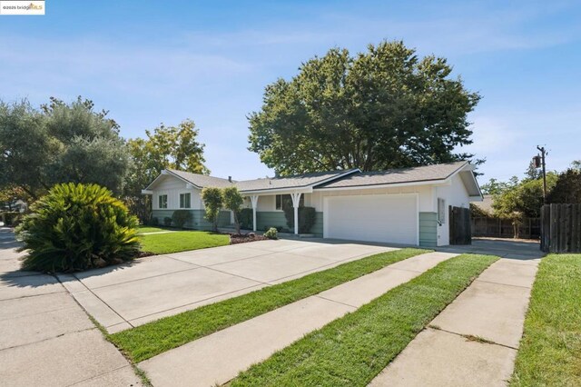 single story home with a garage and a front yard