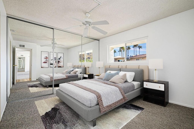 bedroom featuring a textured ceiling, ceiling fan, a closet, and dark colored carpet