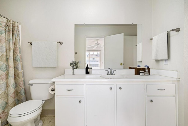 bathroom with toilet, vanity, and ceiling fan