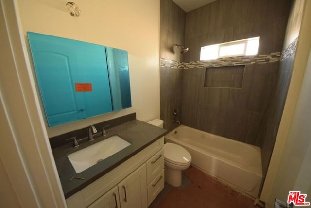 full bathroom featuring tiled shower / bath combo, vanity, and toilet