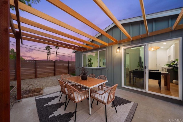 patio terrace at dusk featuring a pergola