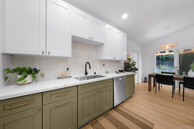 kitchen with lofted ceiling, sink, white cabinetry, dishwasher, and pendant lighting