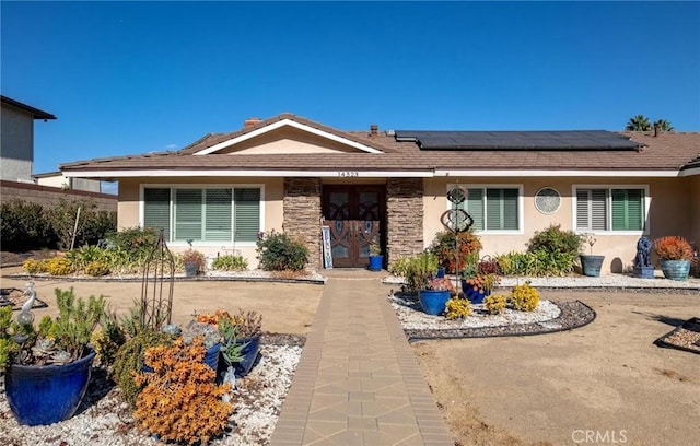 single story home with solar panels