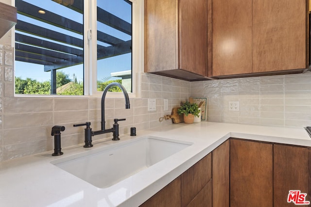 kitchen featuring sink and tasteful backsplash