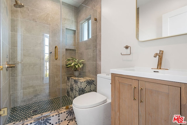 bathroom featuring toilet, vanity, and walk in shower