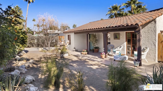 back of property with a patio