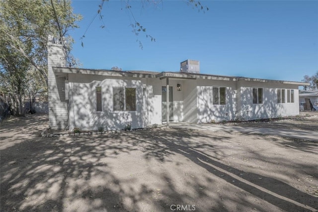 rear view of property with central AC unit