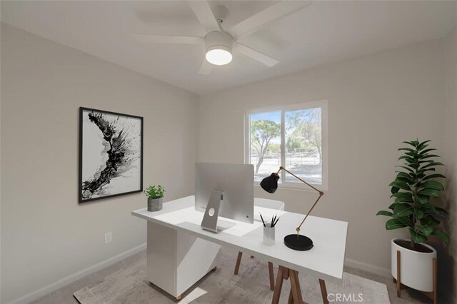 office space with ceiling fan and light colored carpet