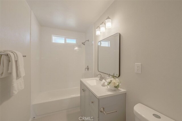 full bathroom with toilet, vanity, and shower / washtub combination