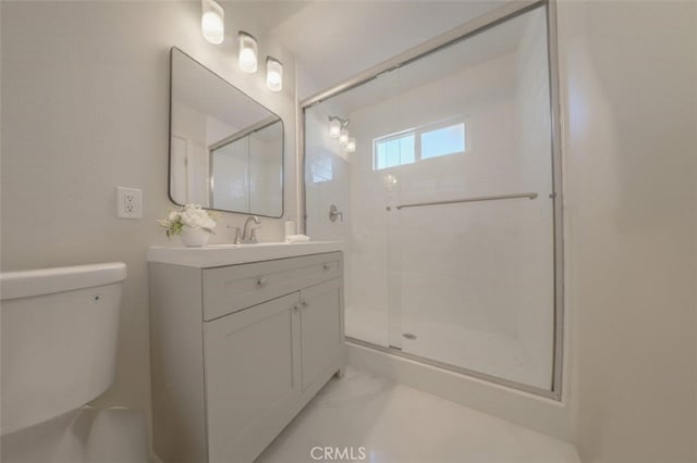 bathroom featuring a shower with shower door, toilet, and vanity