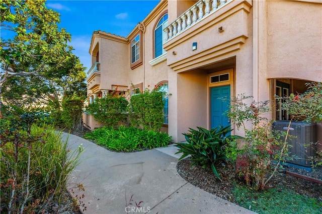 doorway to property featuring a balcony and central air condition unit