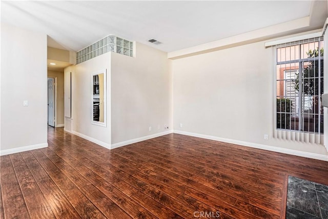 unfurnished room featuring dark hardwood / wood-style floors