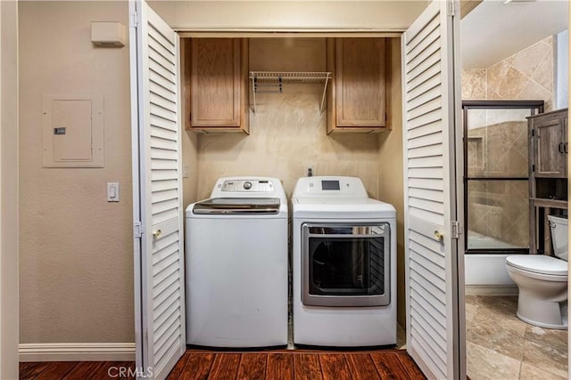 washroom with dark wood-style floors, cabinet space, electric panel, independent washer and dryer, and baseboards