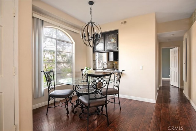 dining room with dark wood-style floors, plenty of natural light, and baseboards