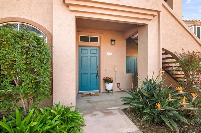 property entrance with stucco siding