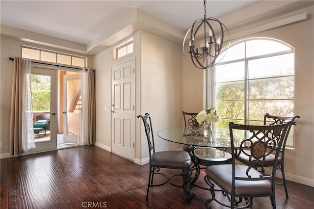 dining space with baseboards, a chandelier, and dark wood finished floors