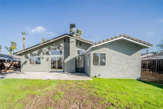 back of house featuring a patio area and a yard