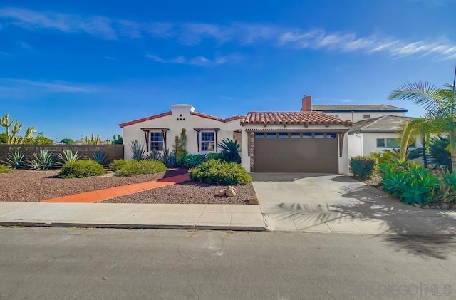 mediterranean / spanish house with a garage