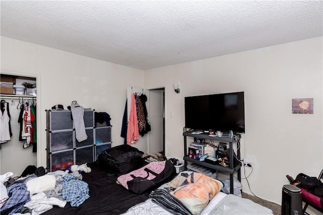 bedroom featuring a textured ceiling, a closet, and carpet