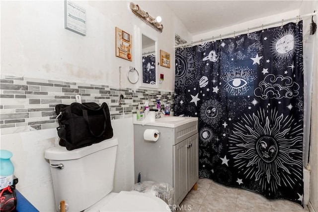 bathroom featuring toilet, vanity, and tile patterned flooring