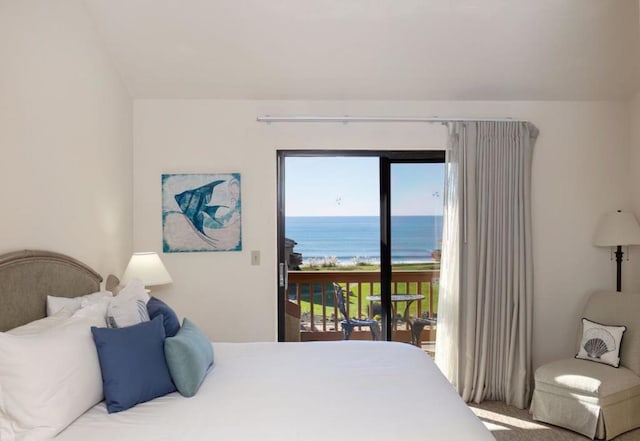 bedroom featuring access to exterior, a water view, and carpet flooring