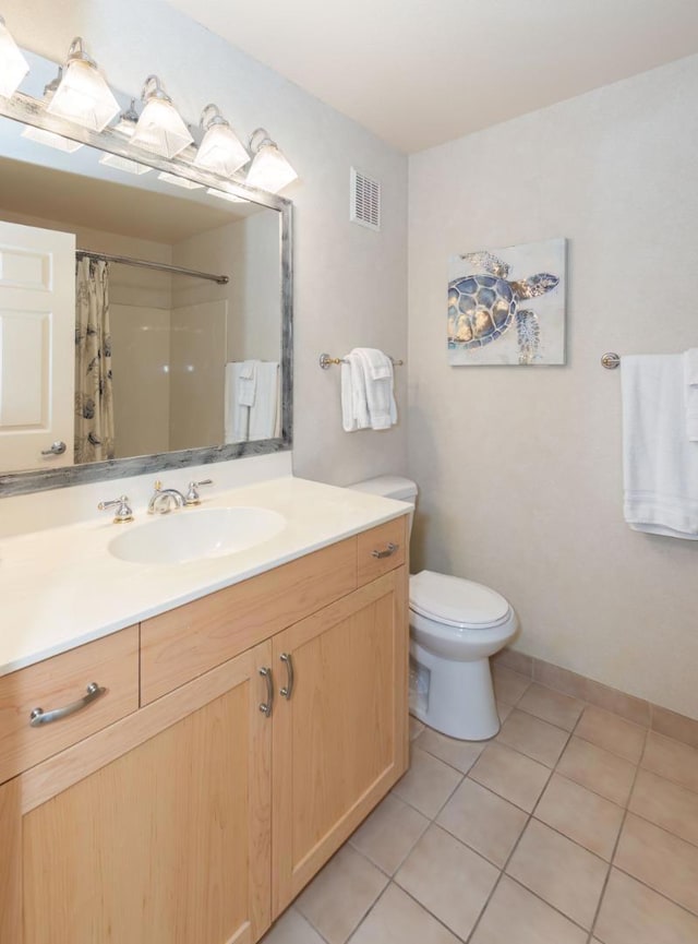 bathroom featuring curtained shower, toilet, vanity, and tile patterned flooring