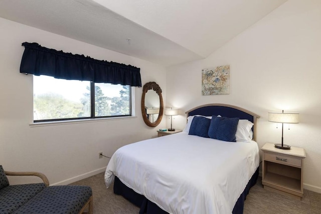 carpeted bedroom featuring lofted ceiling