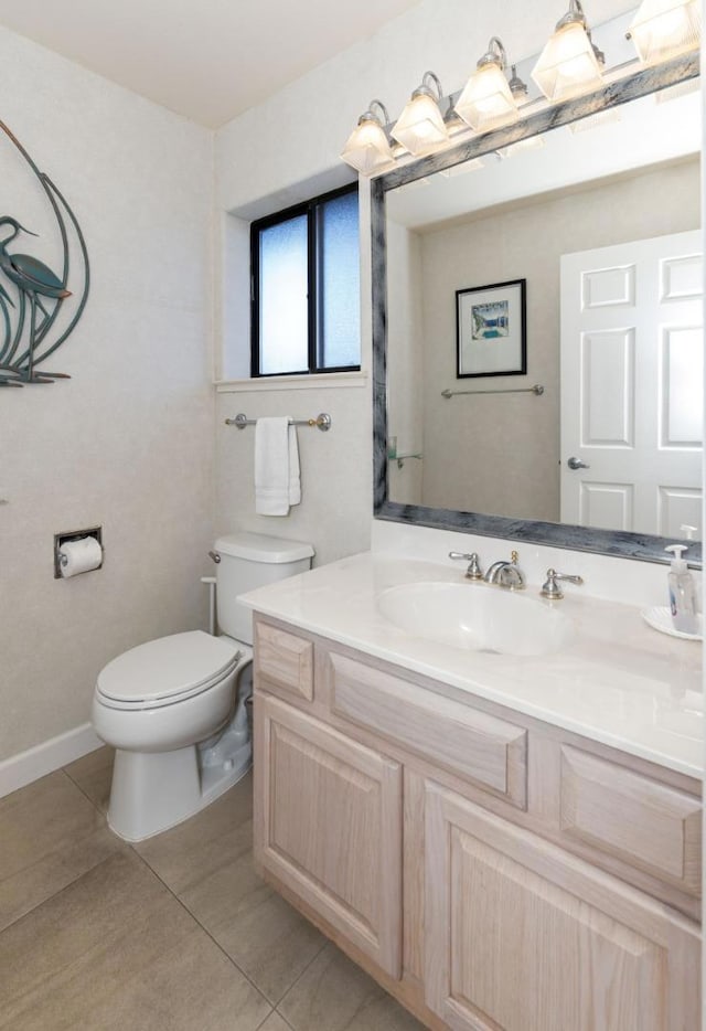 bathroom featuring tile patterned floors, vanity, and toilet