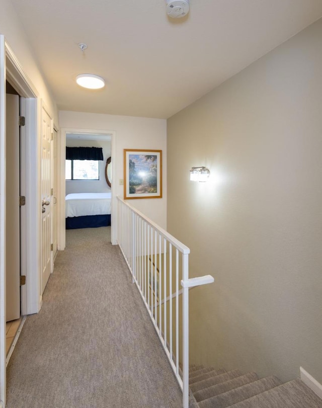 hallway featuring light colored carpet