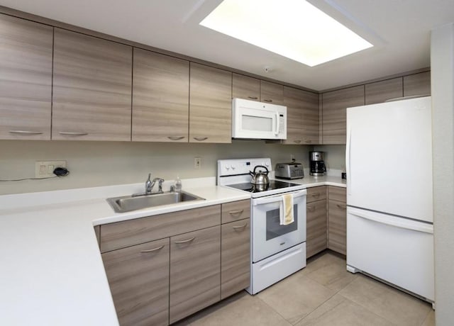 kitchen featuring light tile patterned floors, sink, and white appliances