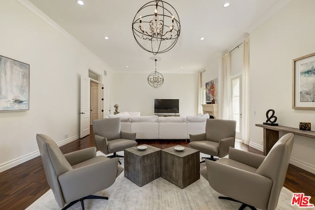 living room featuring dark hardwood / wood-style floors, ornamental molding, and a chandelier