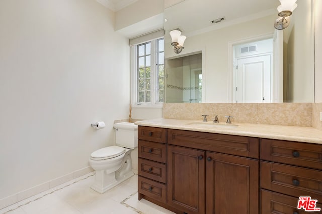 bathroom with toilet, ornamental molding, tile patterned flooring, and vanity