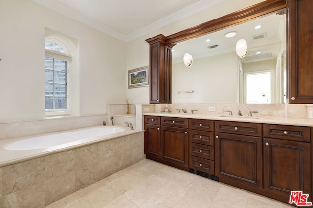 bathroom featuring tiled bath, a wealth of natural light, crown molding, and vanity