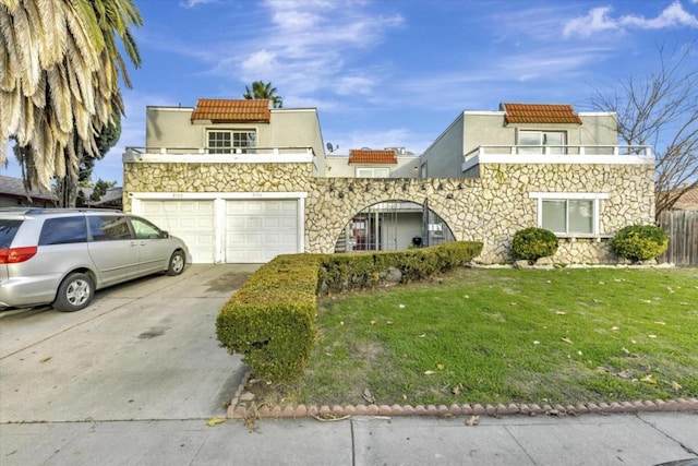 view of front of property featuring a garage and a front yard