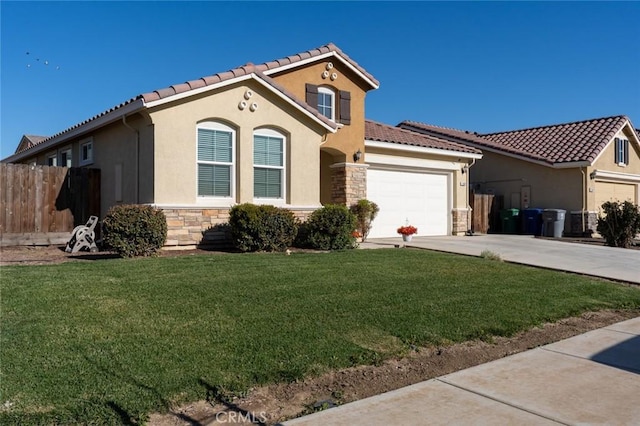 mediterranean / spanish-style home with a front lawn and a garage