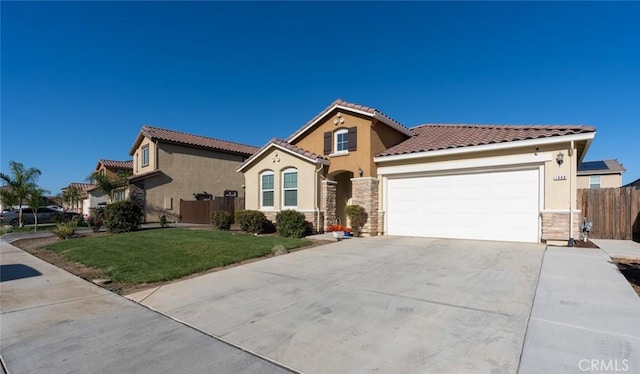 mediterranean / spanish home with a front yard and a garage