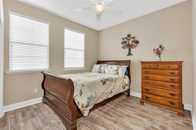 bedroom with ceiling fan and light hardwood / wood-style flooring